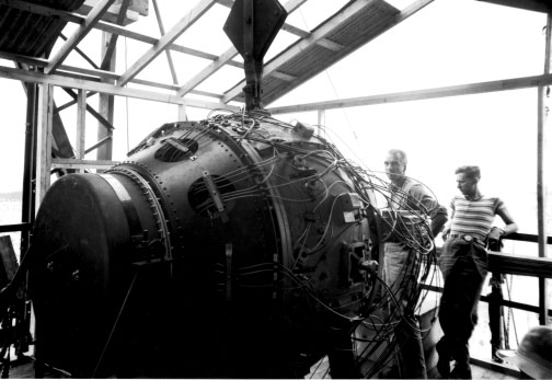 Physicist Norris Bradbury (left) with atomic bomb 'Gadget', 15 Jul 1945
