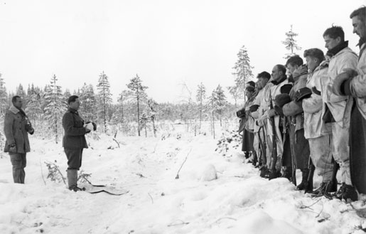 Finnish Army Lieutenant Aarne Juutilainen and his company holding a Christmas service near the Kollaa River, Finland, 24 Dec 1939