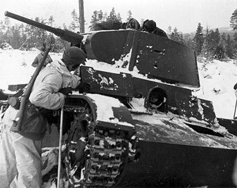 Swedish volunteer fighter inspecting a wrecked Soviet T-26 tank in Finland, 1940