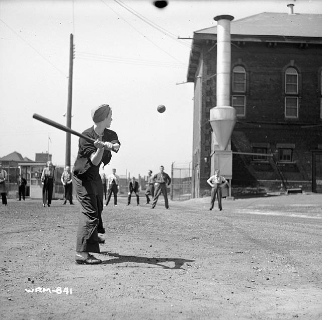Veronica 'Ronnie' Foster playing softball outside the John Inglis and Company factory, Toronto, Canada, 1940s