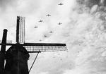 C-47 Skytrains towing Waco CG-4 gliders over Bergeijk, Holland en route the Operation Market Garden landings near Eindhoven, 17 Sep 1944.