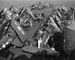 USS Essex forward flight deck spotted with F4U Corsairs and F6F Hellcats as they steam toward Japan, Feb 1945.