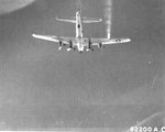 B-17G Fortress of the 15th Air Force flies with No. 4 engine feathered and right wing smoking on a mission to Zwölfaxing, Austria, Jul 8 1944