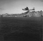 B-24 Liberator of the 98th Bomb Squadron flying past the island of Chi Chi Jima, Japan, 1944-45.