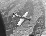 P-51C Mustang of the 311th Fighter Group escorting C-47 Skytrain transports over a terraced landscape in China, July 24 1945