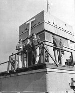 The 4th Fighter Group’s control tower at RAF Debden, Essex, England, UK, Sep 25 1943. Front to Back: BGen Frederick L Anderson, Jr; Mr Donald Nelson, Chief of US War Production; LCol Chesley Peterson, 4th Fighter Group Commanding Officer.