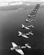 TBF-1 Avengers of Torpedo Squadron 10 from USS Enterprise fly in formation over Espiritu Santo, March 1943.