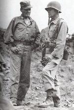 US Marine Colonel Chesty Puller (left) speaks with Assistant Division Commander Brigadier General Edward Craig overlooking Seoul, South Korea, 25 Sep 1950, photo 1 of 2