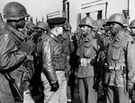 Lt General Lucian Truscott, commanding general of the US Fifth Army in Italy, inspects African-American troops of the 92nd Infantry Division after they threw back a German attack in the hills north of Viareggio, Italy in 1944.