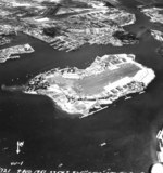Ford Island, Pearl Harbor shipyard, and Hickam Field, Oahu, Hawaii post-war, Aug 4, 1951. Note oil slick streaming from the sunken Arizona, upper left.