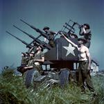 Canadian personnel man a portable Triple Polsten 20mm anti-aircraft mount, a descendant of the Oerlikon design. France, Jun 1944.