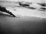 SB2C-3 Helldiver from USS Hornet (Essex-class) overflying burning tanker Kyokuun Maru heading for the beach in French Indochina (Vietnam) north of Qui Nhon after being attacked by 175 USN carrier planes, Jan 12, 1945