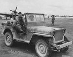 Maj General Willis H Hale (front seat) and Vice Admiral John H Hoover tour Aslito Field, Saipan, Marianas (later Isley Field), Jun 28, 1944, ten days after the area was captured from the Japanese. Note P-47 Thunderbolt.