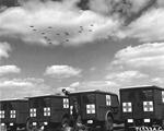 WC-54 ambulances at RAF Kimbolton, England waiting as returning B-17 Fortress bombers of the 379th Bomb Group fly overhead, May 13, 1944