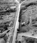 The first convoy to use new Ledo Rd at Mile Zero marker at the railhead of Ledo, India, Jan 12, 1945.  The Ledo Road connected with the old Burma Road as part of the effort to truck supplies to Kunming, China
