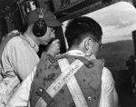 US Army Ground Liaison Officer Maj Mortimer H Jordan, headphones, relays information from Japanese POW 2Lt Minoru Wada to guide the bombing strike to the target area, Aug 9, 1945, Mindanao, Philippines