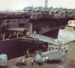 F6F-3 Hellcats being loaded aboard USS Yorktown (Essex-class) at Norfolk, Virginia, 1943.