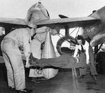 A "patient" being prepared for transport during a drill, 1944. The aircraft is an F-5B Lightning fitted with two drop tanks modified for use in high speed medevac operations