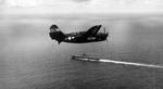 SB2C Helldiver of Bombing Squadron VB-86 approaching the carrier Wasp (Essex-class) near Japan, 1945. Note the white radar pod under the wing.