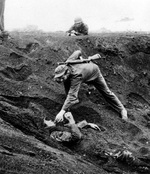 This Japanese soldier played dead for almost two days half buried in a shell hole holding a live grenade. Promising no resistance, he was given a cigarette before being removed from the hole, Iwo Jima, Mar 16, 1945
