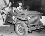Stars and Stripes correspondent and cartoonist Bill Mauldin at the wheel of his assigned Jeep accompanied by fellow illustrator Gregor Duncan, Naples, Italy, Mar 1944