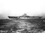 Portside broadside view of USS Yorktown (Essex-class) at Newport News, Virginia, United States, on her way to her commissioning ceremonies at Norfolk Navy Yard, 15 Apr 1943