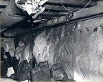 Bulging bulkhead in No. 3 Ready Room on the gallery deck of USS Intrepid from the explosion of a Japanese special attack aircraft in the hangar deck spaces, off the Philippines, 25 Nov 1944