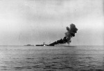 The USS Bunker Hill, already burning from one special attack aircraft, is struck by another off Okinawa, 11 May 1945. Note cruiser USS Wilkes-Barre at left.