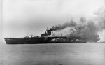 The USS Bunker Hill, burning from two special attack aircraft crashing through the flight deck off Okinawa, is assisted by destroyer Charles S Perry and cruiser Wilkes-Barre, 11 May 1945.