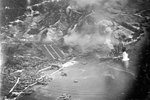 Carrier aircraft of US 3rd Fleet planes attacking battleship Haruna, Kure, Japan 28 Jul 1945; photo taken by aircraft from USS Wasp (Essex-class)