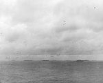 The US Third Fleet steaming in tight formation for a photo opportunity as close to 200 airplanes fly overhead, 22 Aug 1945. Photo taken from USS Wasp (Essex-class). Note five Light Carriers.