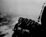USS Wasp (Essex-class) rolls in heavy sea as the ship steamed into a typhoon south of Japan, 25 Aug 1945.