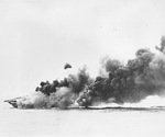 USS Hancock maneuvering to control fires after being hit by a Japanese special attack aircraft off Okinawa, Japan, 7 Apr 1945