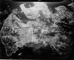 Strike photo taken by USS Hancock aircraft showing an attack on the Yokosuka Navy Yard, Tokyo Bay, Japan, 18 Jul 1945. Note bomb splashes.