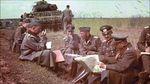 German Generaloberst Heinz Guderian holding a map during a field briefing with his division commanders in Russia in front of a PzKpfw III medium tank, summer 1941