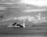A water plume from a torpedo striking against the bow of super-battleship Musashi rises high in the air during the Battle of the Sibuyan Sea, 24 Oct 1944