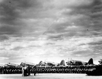 Training Squadron 17 lining up for their graduation photo at the Naval Air Station at Corpus Christi, Texas, United States, circa 1942. Note OS2U Kingfisher aircraft.