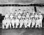 Vice Admiral Marc Mitscher (front row center) and his Fifth Fleet staff photographed on the hangar deck of USS Enterprise on the occasion of coming aboard, 11 May 1945. Note Commodore Arleigh Burke next to Mitscher.