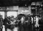 Burned and demolished F6F-5 Hellcat on the hangar deck of USS Ticonderoga following a special attack plane crashing through the flight deck and exploding in the hangar deck southeast of Formosa (Taiwan), 21 Jan 1945.