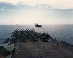 View from the island of USS Hornet (Essex-class) looking aft and leading the USS Bonne Homme Richard, USS Belleau Wood, and USS San Jacinto during gunnery exercises, 12 Jun 1945 off the Philippines.