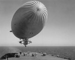 US Navy K-class airship K-111 conducting exercises with Escort Carrier USS Rudyerd Bay off San Diego, California, United States, 30 Mar 1943.