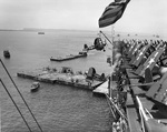 F4U Corsair fighters being offloaded from escort carrier USS Altamaha onto a barge at Guiuan Harbor, Samar, Philippines, 1 May 1945