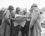 LtGen Omar Bradley, LtGen George Patton, and MGen Manton Eddy being shown a map by one of Patton’s Armored Battalion Commanders during a tour near Metz, France, 13 Nov 1944