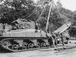 US Army M4 Sherman tank fitted with a crane lifting a pre-fabricated bridge tread section in France, mid-late 1944.
