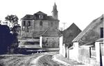 Lidice, Czechoslovakia in the 1930s. St. Martin’s church built in 1732 with one of the village’s barns in the foreground.