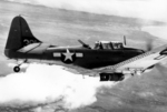 A United States Marine Corps SBD Dauntless light bomber in flight over Guadalcanal, Solomon Islands, late 1942.