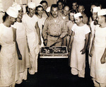 Commander A. M. Loker celebrating victory with cake aboard USS Oahu while at Eniwetok, Marshall Islands, 15 Aug 1945