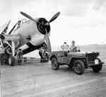 A Jeep on the deck of the USS Yorktown (Essex-class) being used as an aircraft tug during the strikes on Wake Island, 5 Oct 1943. In this case, the Jeep is being hooked to a TBM-1C Avenger.
