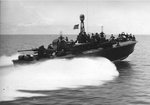 Elco 80-foot torpedo boat PT-122 traveling at speed, 1944-45. Note Mark XIII aerial torpedoes in their racks have replaced the heavy steel torpedo tubes allowing for Bofors 40mm gun aft and 37mm cannon forward.