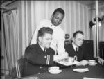 African-American steward serving Caucasian-American officers aboard a US destroyer, Londonderry, Northern Ireland, United Kingdom, Jan 1942